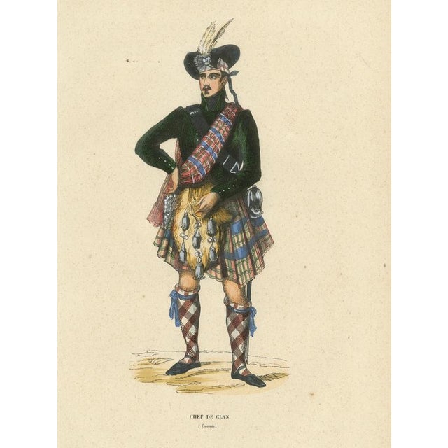 This striking lithograph depicts a Scottish clan chief wearing full Highland dress, including tartan, sporran, and...