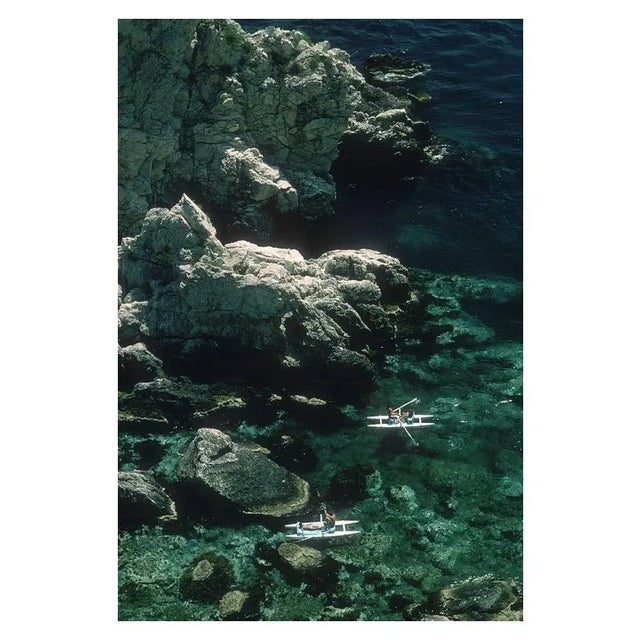 Rowing Off Sicily 1975 Two couples out rowing off the coast of Sicily near Taormina, 1975. Slim Aarons Slim Aarons was one...