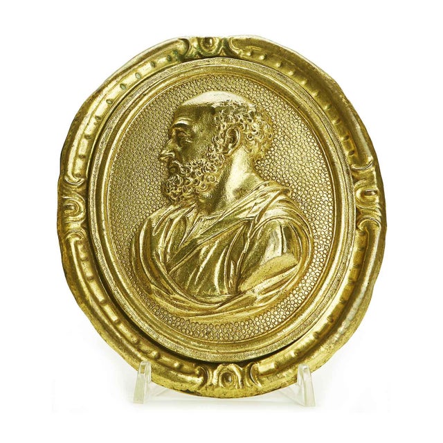 Pair of Gilded Bronze Plaques with Profiles of Saints: A pair of 18th-century gilded oval reliefs composed of two...