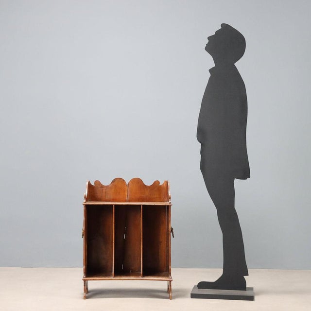 Small portable walnut bookcase. Curved upper balustrade, sides, and bracketed feet. Bronze side handles with mask motifs....