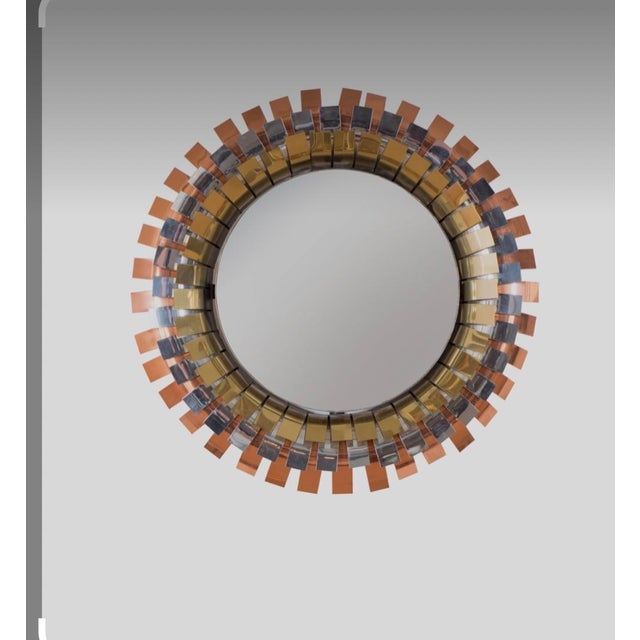 The Curtis Jeré mixed metal "eyelash" sunburst mirror is a stunning piece of Mid-Century Modernism design from the 1970s....