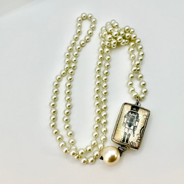 Vintage Home is pleased to present this stunning Christmas Pendant Necklace, after Chanel. The faux pearl necklace is 40”...