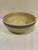 Vintage stoneware mixing bowl featuring traditional cobalt blue banded stripes and a warm cream glazed finish. The classic...
