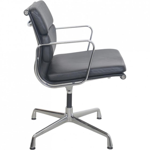 Charles Eames EA208 softpad chair upholstered in black leather, and with chrome armrests and base. The chair is from 2007...