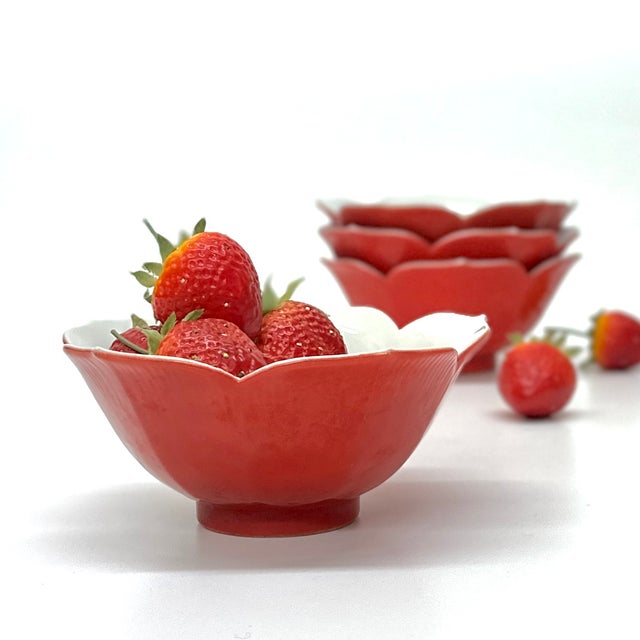 Matte red porcelain bowls, Group of 4. An eclectic set of mid-20th-century matte red and white porcelain serving bowls,...