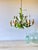Vintage six-light tole chandelier constructed of painted metal with hand-formed floral and foliate decoration. The fixture...