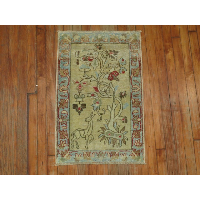 a Sweet Persian Pictorial mat in tan light blue and red accents Details rug no. r5046 size 1' 9" x 2' 9" (53 x 84 cm)
