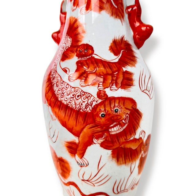 Vintage Chinese porcelain Hu-form vase, featuring expressive hand-painted foo lions in rich iron-red against a white...
