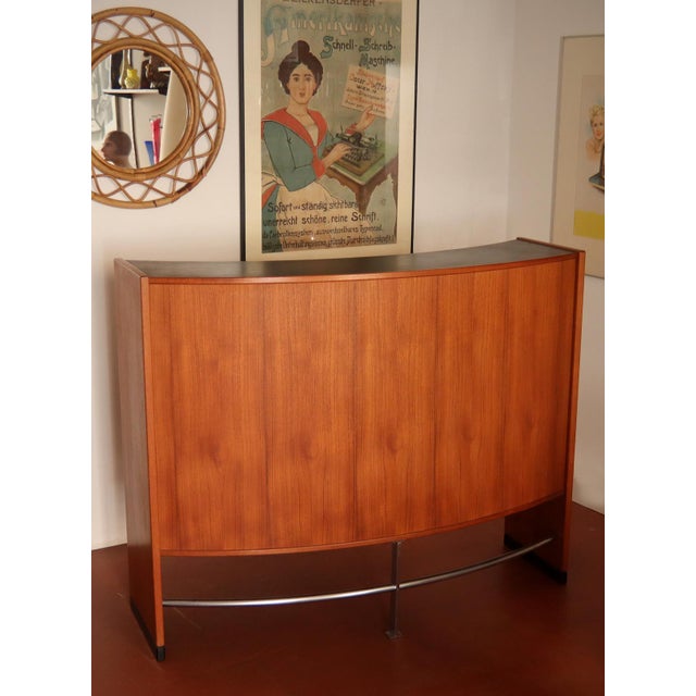 A very sophisticated freestanding bar cabinet with two bar stools, designed by Erik Buch for Dyrlund, Denmark, 1960. This...