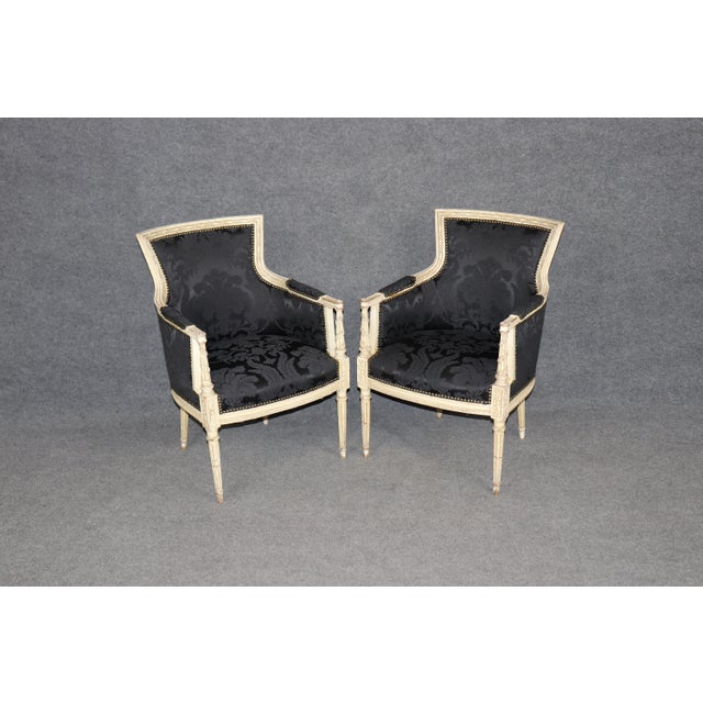 Elevate your interior with this stunning pair of French Louis XV style bergère chairs, newly upholstered and beautifully...