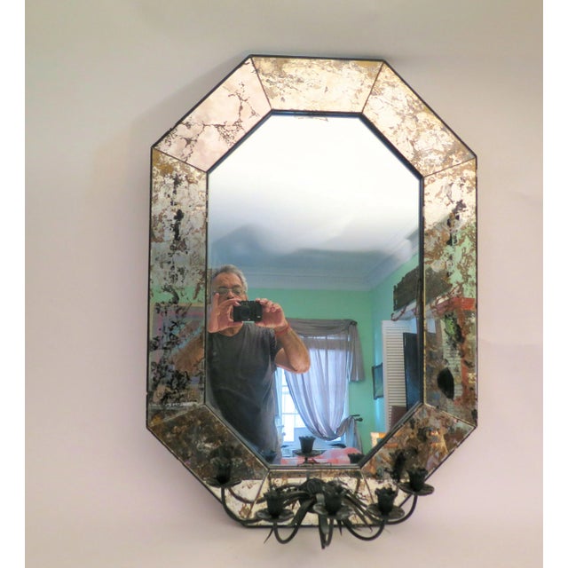 A rare Vintage Venetian Regency mirror with 5 Italian wrought iron candle holders. This beautiful mirror with 5 lit...