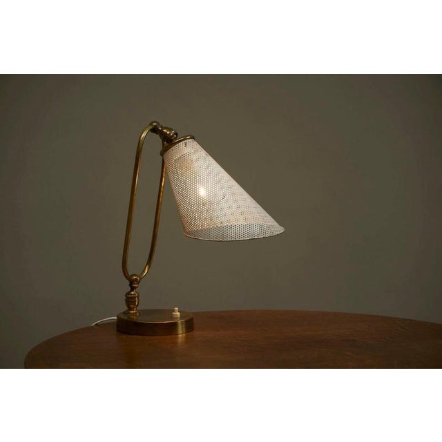 This is a truly wonderful articulating mid century table lamp in beautifully patinated brass and perforated white...