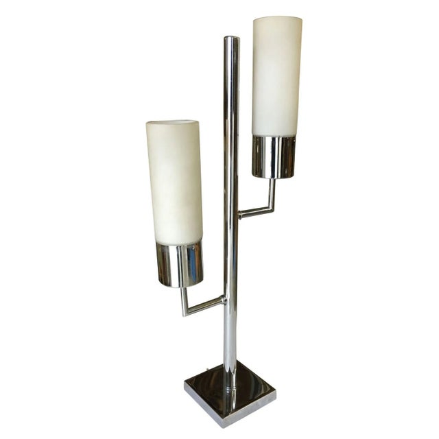 Modernist, Mid-Century inspired twin cylinder lamp featuring a chrome base and body featuring two 2 lights each with a...