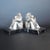 A pair of art deco bookends by fontinelle in the form of stylised, silvered bronze pierrots seated on marble plinths....