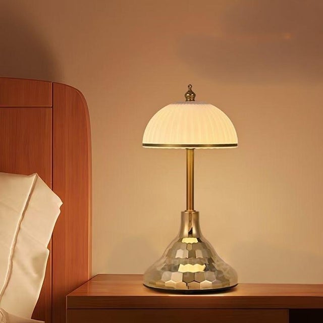 White porcelain vertical-texture shade (with small gold bead finial), layered white porcelain lamp body (with glowing...