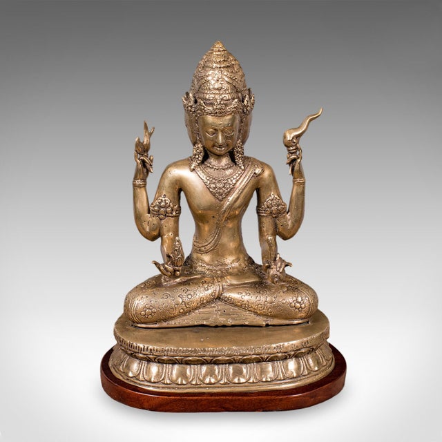 This is an antique Dattatreya figure. A Balinese, bronze religious icon portraying a Hindu Trimukha statuette, dating to...