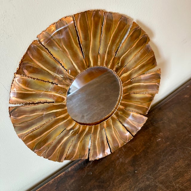 Torch-cut brass sunburst mirror.