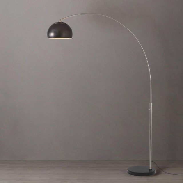 Designed by Peter Morelli in 1960, the Half Dome Arc Lamp is a modern masterpiece featuring a satin nickel steel body and...
