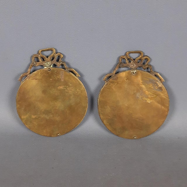 Beautiful pair of antique miniature paintings, depicting a young lady made with the retouché technique with glass...