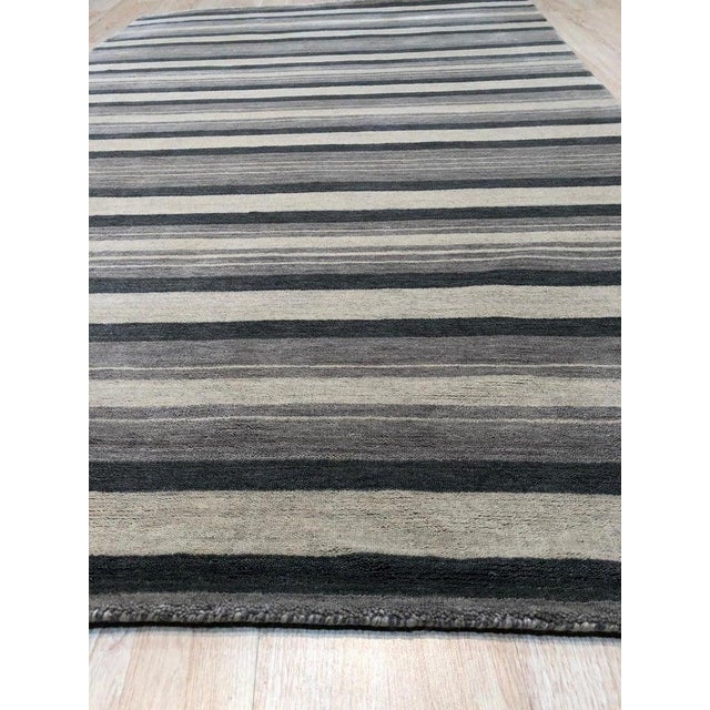 This multicolor jewel tone rug features a hand knotted pile construction made from wool. Designed in the Dhurrie style, it...