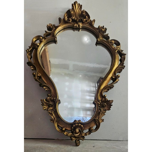 A beautiful Mid-Century giltwood Italian Provincial wall mirror. Excellent condition! This also comes with two beautiful...