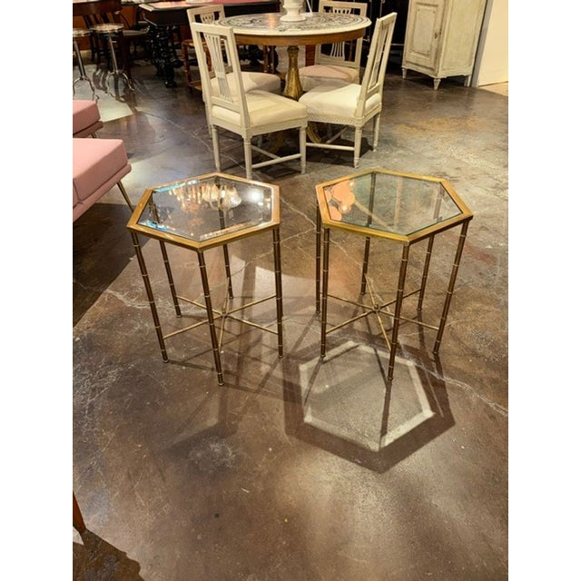 The Pair of MCM Mastercraft Brass Side Tables is a set of stylish and elegant furniture. Crafted from brass with bamboo...