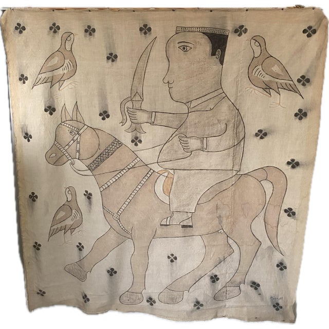 A vintage Indian hand-painted cotton wall hanging depicting a stylized horseman figure surrounded by bird and floral...
