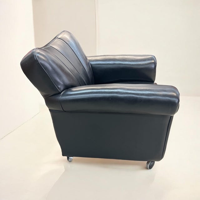 This club chair with a very soft black leather cover is a high-quality piece from the 1950s that cites classic Art Deco...