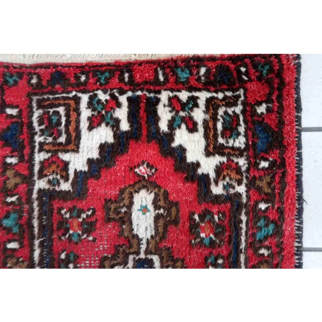 Handmade vintage Persian Hamadan rug in distressed condition. The rug has been made in wool in the end of 20th century....