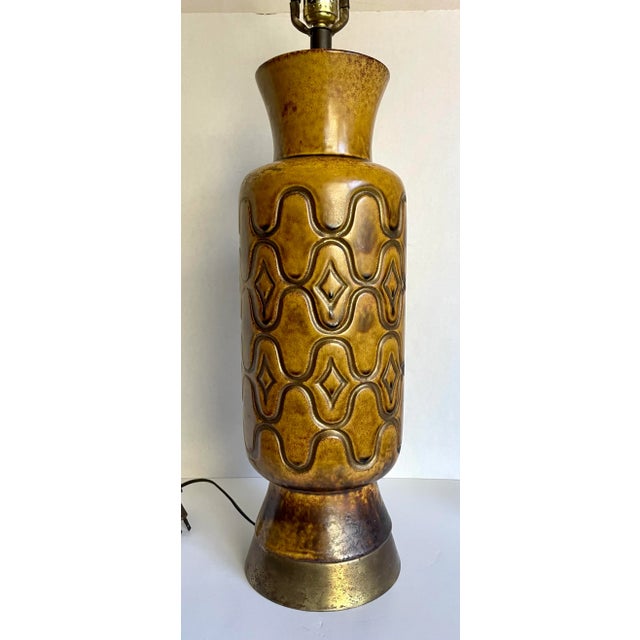 Here is a fantastic art lamp from the mid-century featuring a ceramic pottery body with geometric, etched details and a...