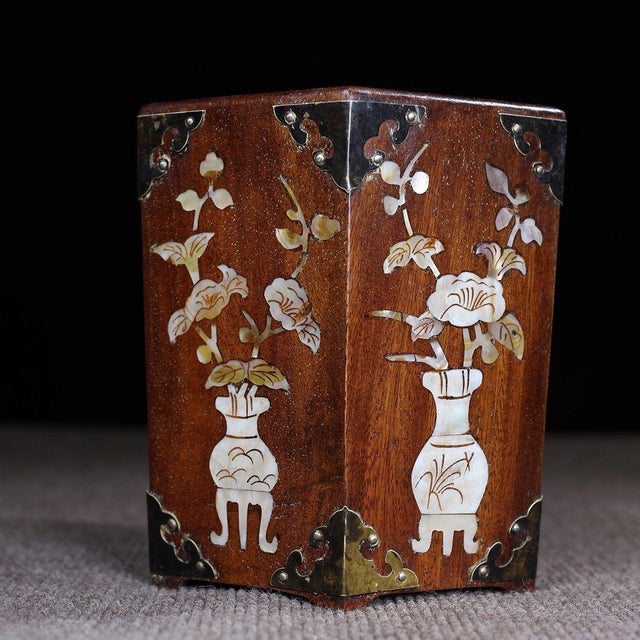 A beautifully crafted Chinese hexagonal brush pot (bitong), likely made of Huali (rosewood). The vessel is exquisitely...