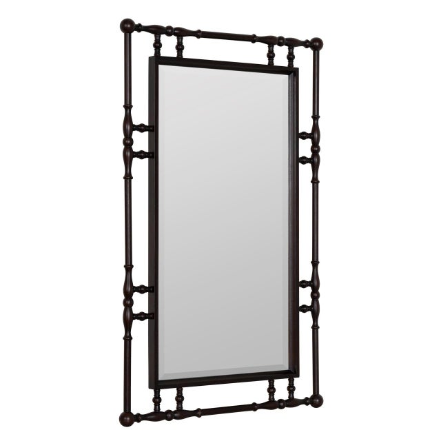 A rich espresso-toned rubber wood frame with hand-turned spindle and finial detailing gives the Bria Hammel Bowery Mirror...