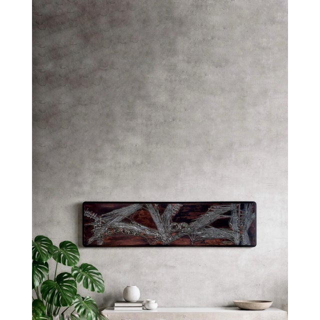 An impressive abstract modern steel relief with wooden frame, created in 1975 by the German artist Manfred Jung (*1940)...