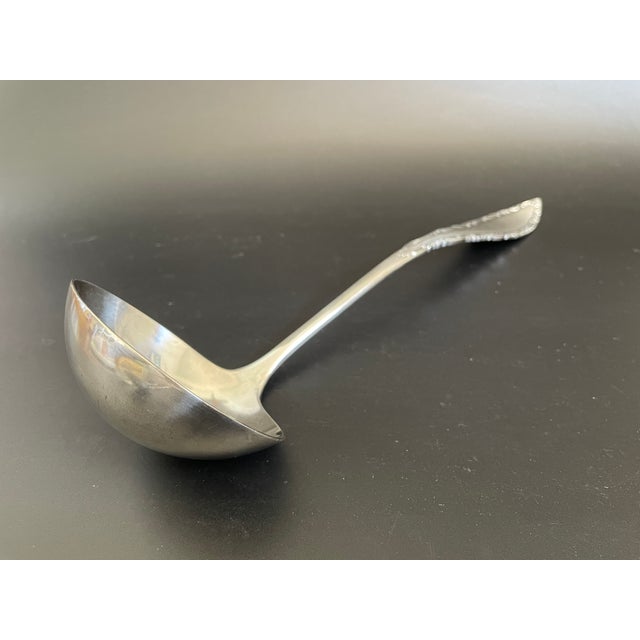 A large solid oyster ladle in the Savoy pattern by International Silver / Rogers & Brother. This Victorian design features...