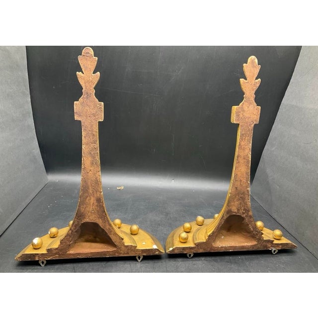 A striking pair of vintage giltwood-style wall brackets in the neoclassical Hollywood Regency taste. Featuring dramatic...