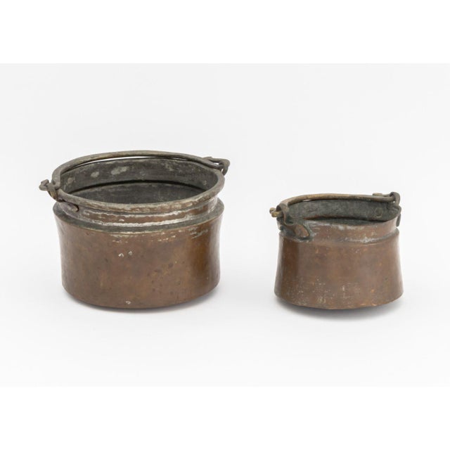 Antique Copper and Brass Cauldrons, 18th century, dovetail seams, larger with pattern to handle. Larger: 6.5" H x 10.5" W...