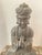Heavy and large a wooden Buddha statue, specifically a seated figure in a meditative pose with hands clasped in prayer...