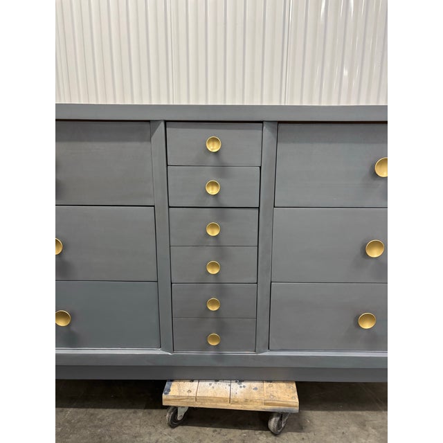Offered is a solid mahogany dresser with ten dovetailed, smooth gliding drawers. This piece is stained a blue/gray color...