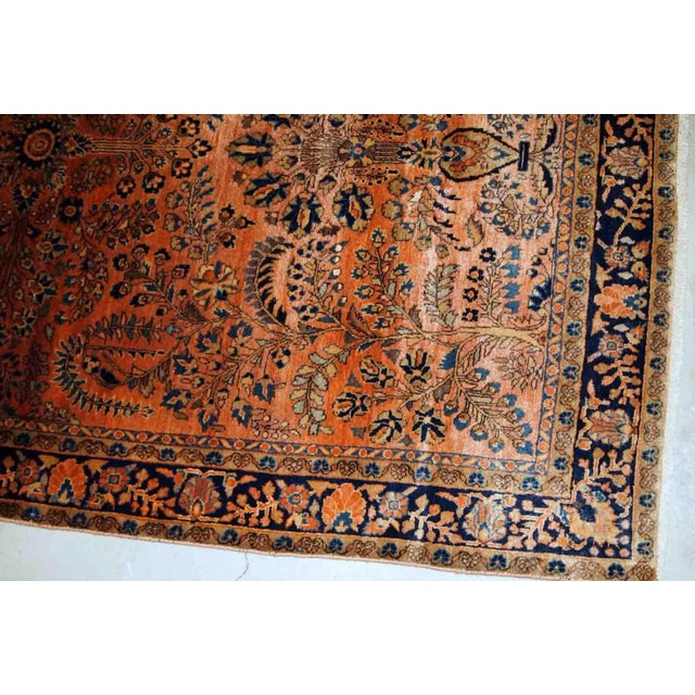 Handmade antique Sarouk rug in original good condition. The rug has been made in the beginning of 20th century in pale red...