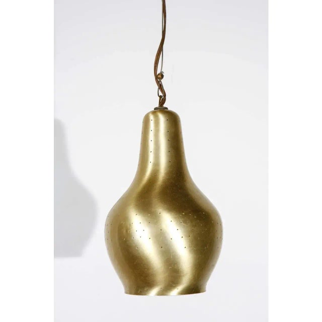 Paavo Tynell counterweight pendant with a satin brass finish. Newly rewired for one standard lightbulb.