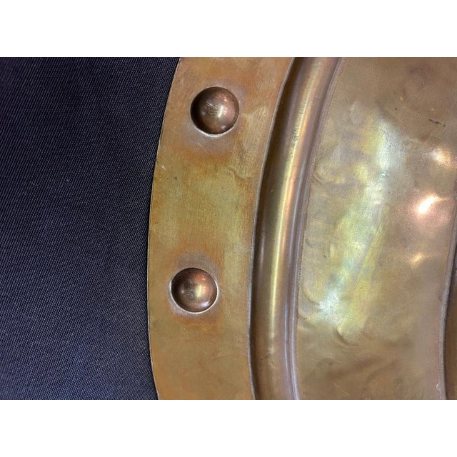 Bronze and brass shield with an eagle at the top.