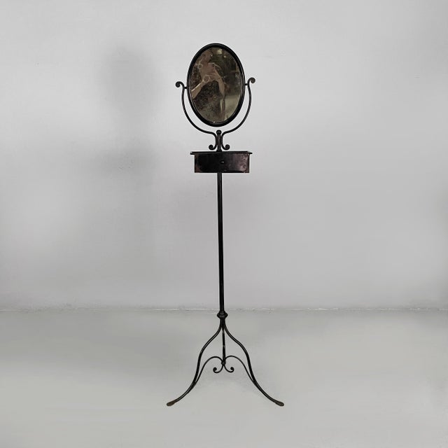 Italian black metal console with mirror and drawer, late 1800s Console table with tilting oval mirror and a black metal...