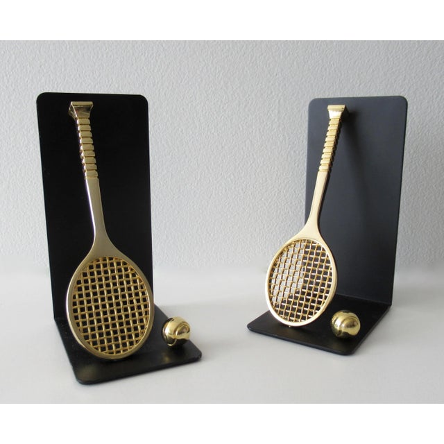 Vintage:m C.1980's Brass tennis racket and ball bookends, made exclusively for Lord & Taylor Dept. Stores, for the...