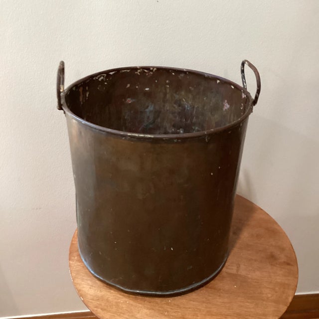 Antique Dutch neoclassical log basket. The firewood basket is made of copper and brass with wrought iron handles. Also...