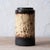 A West German fat lava vase in cylindrical form, glazed in a heavy dripping brown, cream, and black volcanic glaze, circa...