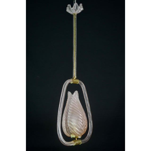 Charming Murano chandelier by artist Ercole Barovier in rare pink colour. The pendant consists of 6 glass elements and a...
