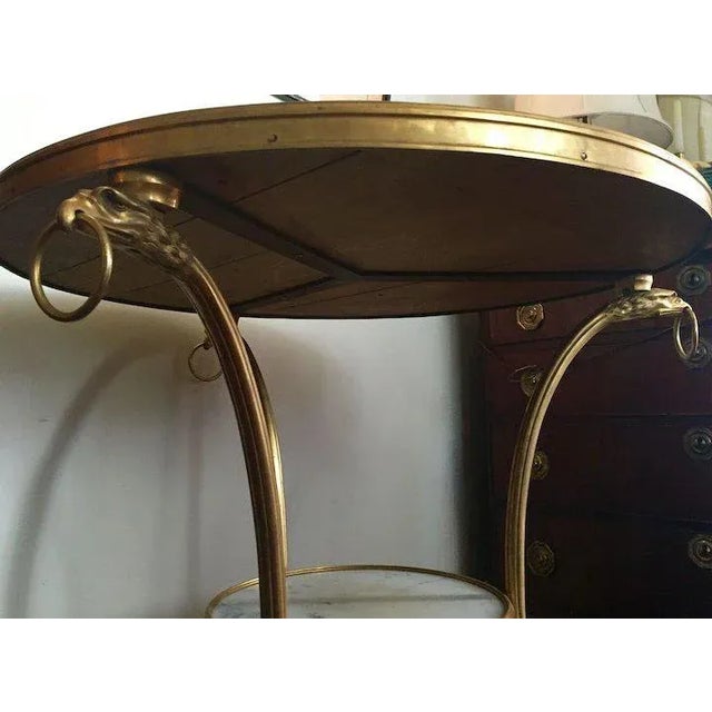 Antique French gilt bronze and white marble guardian table in the Empire taste with eagle head ring handles and bird talon...