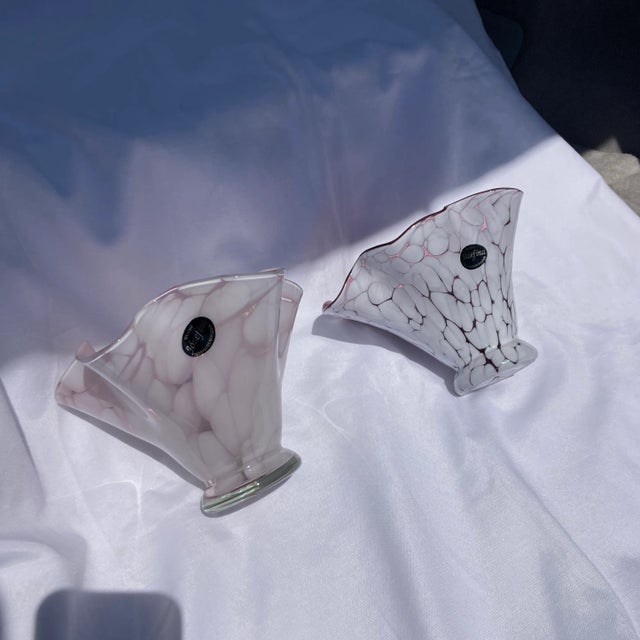 This set includes two 7 inch wide and 5 inch tall crackly finished bowls/vases . One is white with a pink hue inside and...