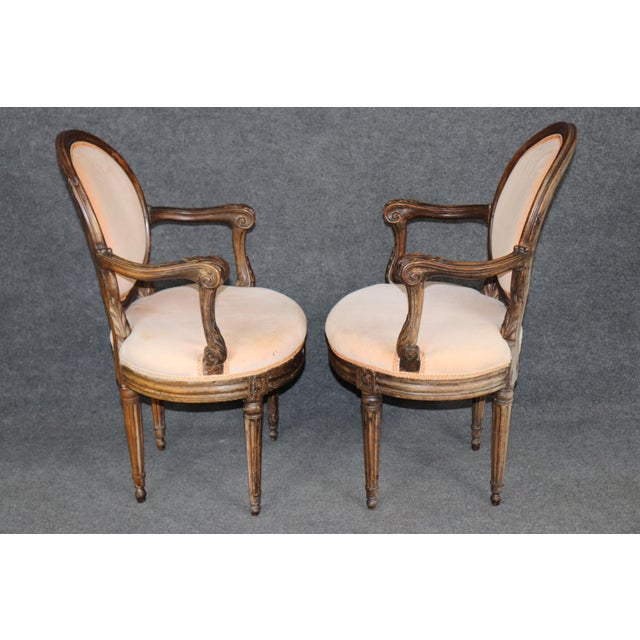 Introduce authentic 18th-century elegance into your interior with this exceptional pair of period French Louis XV walnut...