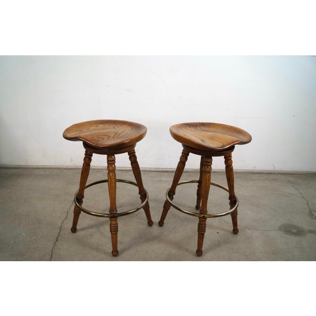 American 1970’s Solid Oak & Brass Tractor Swivel Counter Stools - A Pair For Sale - Image 3 of 12